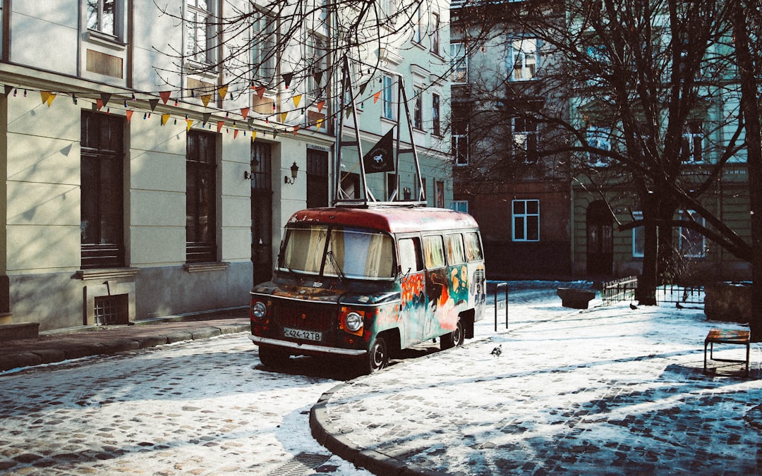 black and multicolored van beside building