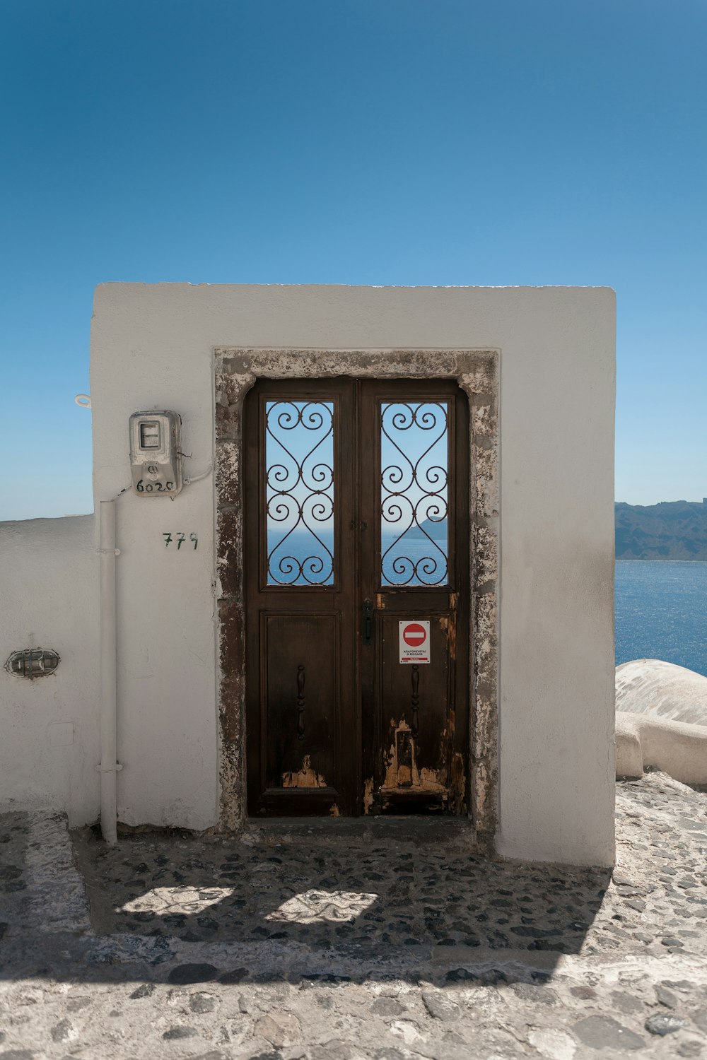 closed brown door facing body of water