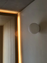 An intimate interior space with minimalist furniture and warm lighting highlighting textures.