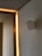 A minimalist interior with a clean, modern design. Soft lighting creates a warm ambiance along the wooden paneling. The neutral tones of the walls and ceiling complement the subtle geometric features.