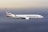 A large commercial airplane with the American logo is flying through an open sky with soft gradient hues ranging from light blue to gray.