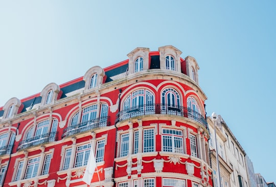 low angle photo of red and white painted structure in Majestic Café Portugal