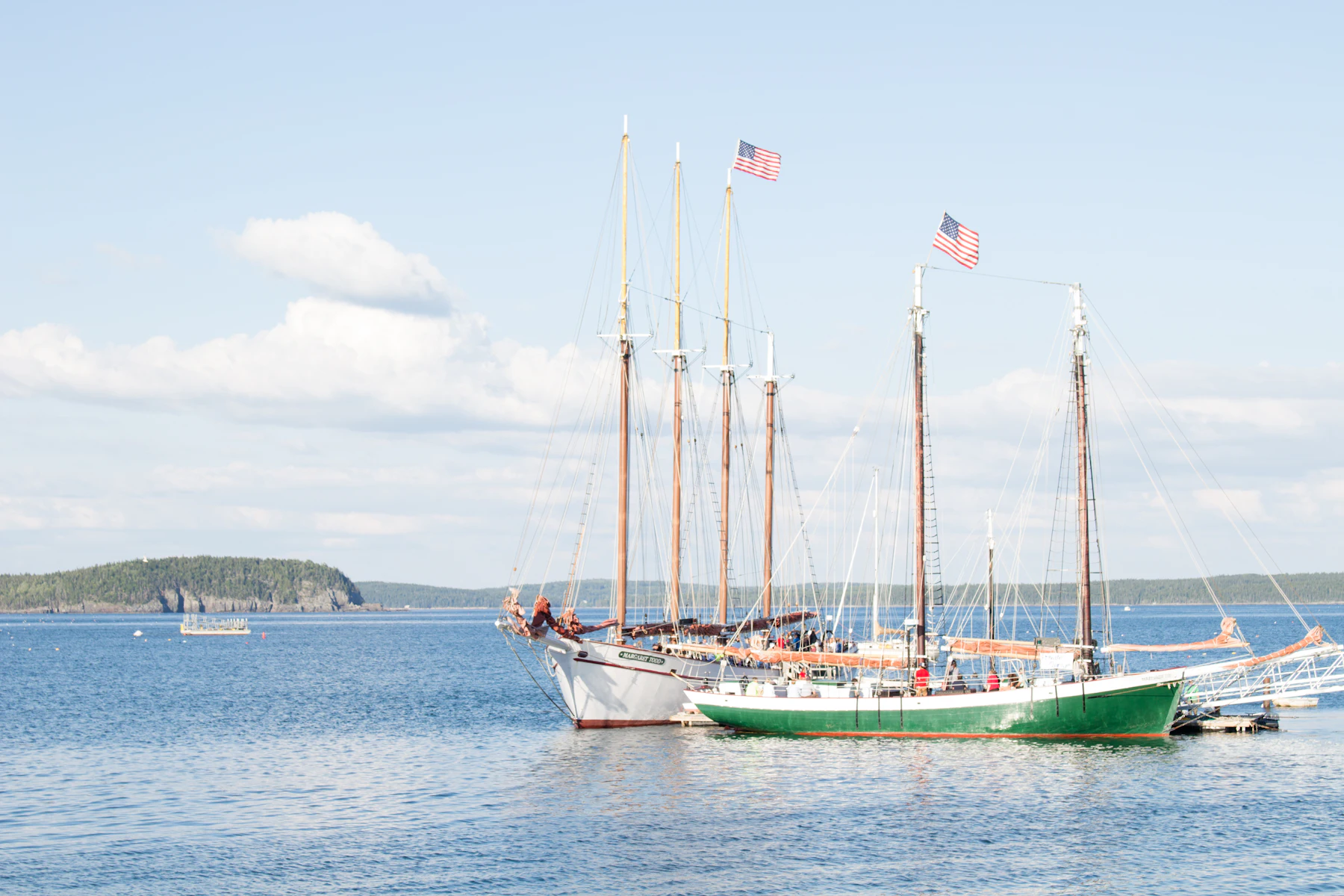 Tall ships with American flags moored in a New England harbor