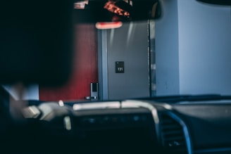 a person is sitting in a car looking at their cell phone