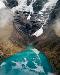 body of water between mountains at daytime