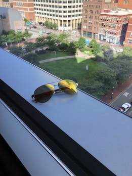 A pair of sleek lenses reflecting a city skyline at sunset.