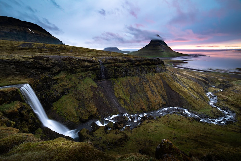 waterfalls in the middle of mountains