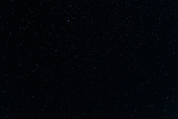 Person alone at night looking at city lights