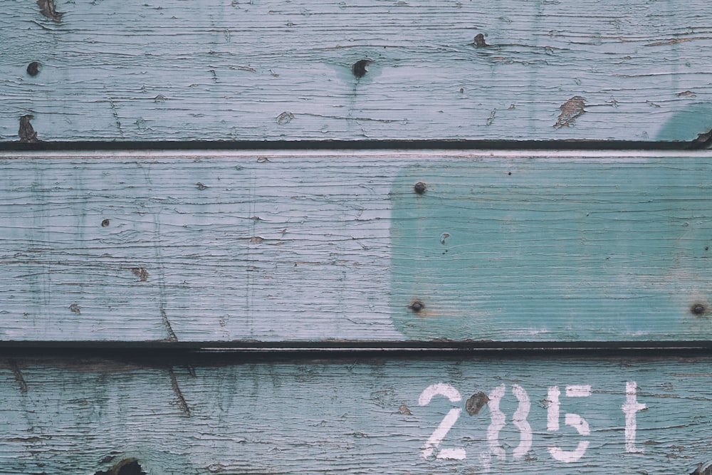 a close up of a stop sign on a wooden wall