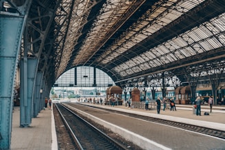 people standing inside gray station during daytime