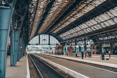 people standing inside gray station during daytime