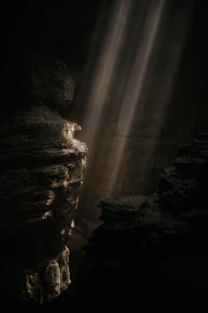 a light shines through a crack in the rocks