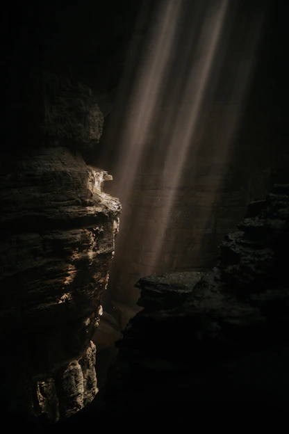 a light shines through a crack in the rocks