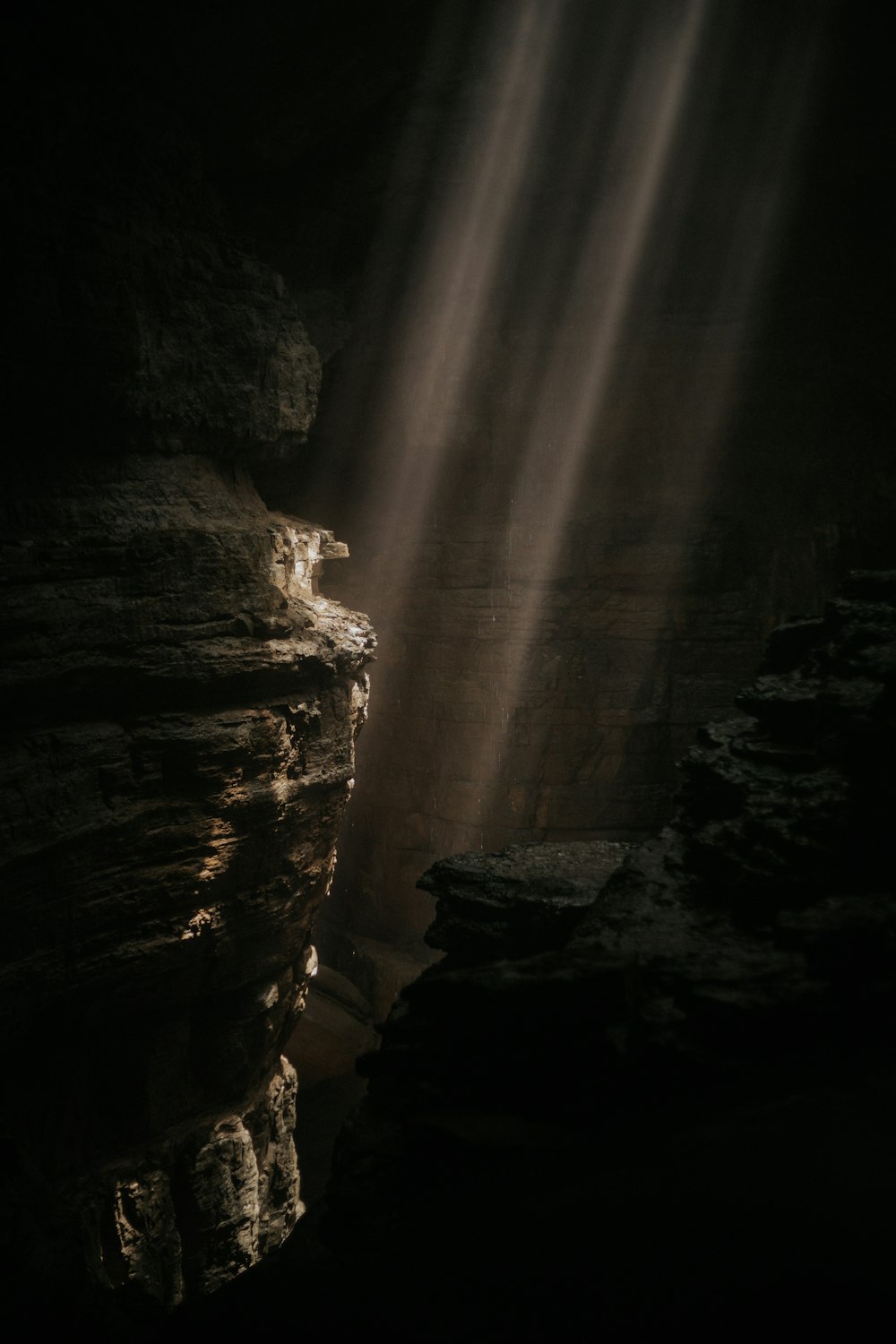 a light shines through a crack in the rocks