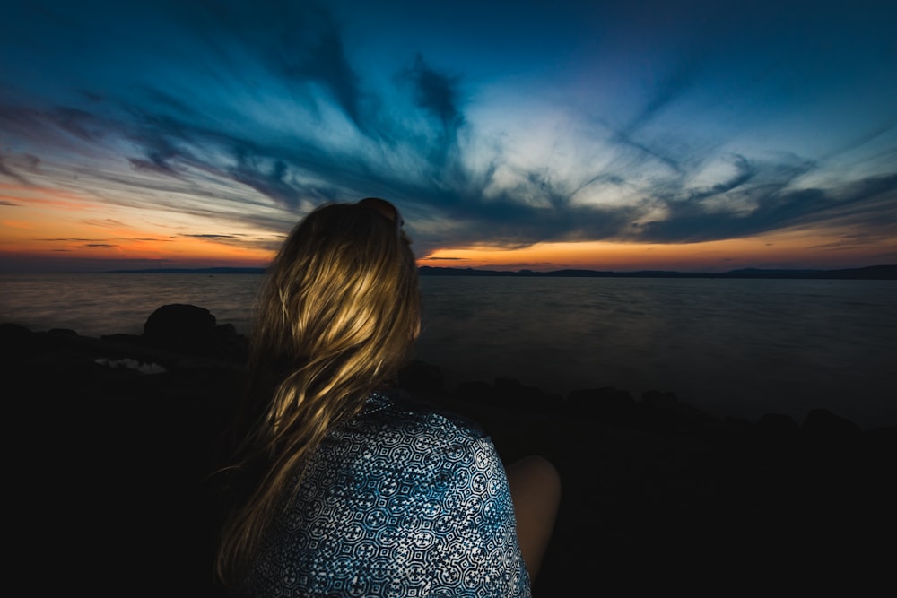 person facing sunset by the sea