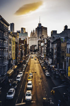 A vibrant street scene at golden hour with bustling city life.