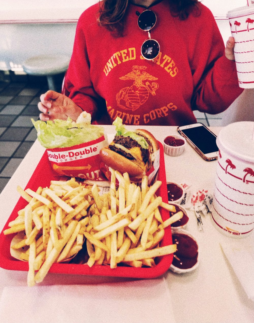 fries and burger in red container