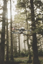 gray and black DJI Mavic Pro quadcopter drone on mid top air near forest at daytime
