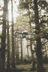A drone equipped with thermal imaging flying over a dense forest for environmental monitoring.