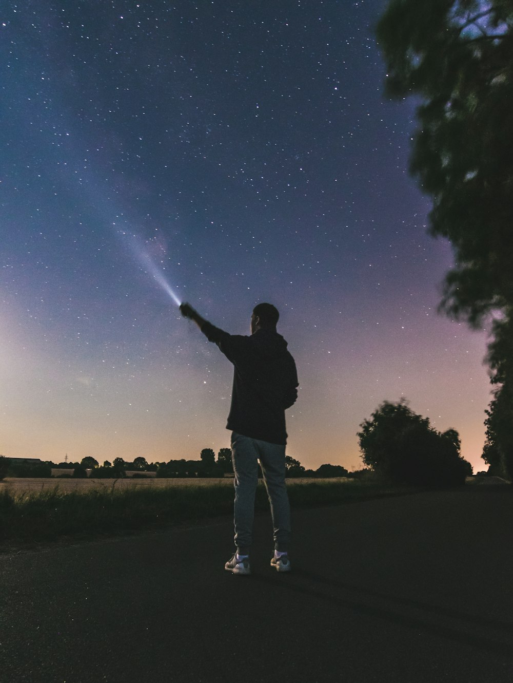 force photography standing man using flashlight at star