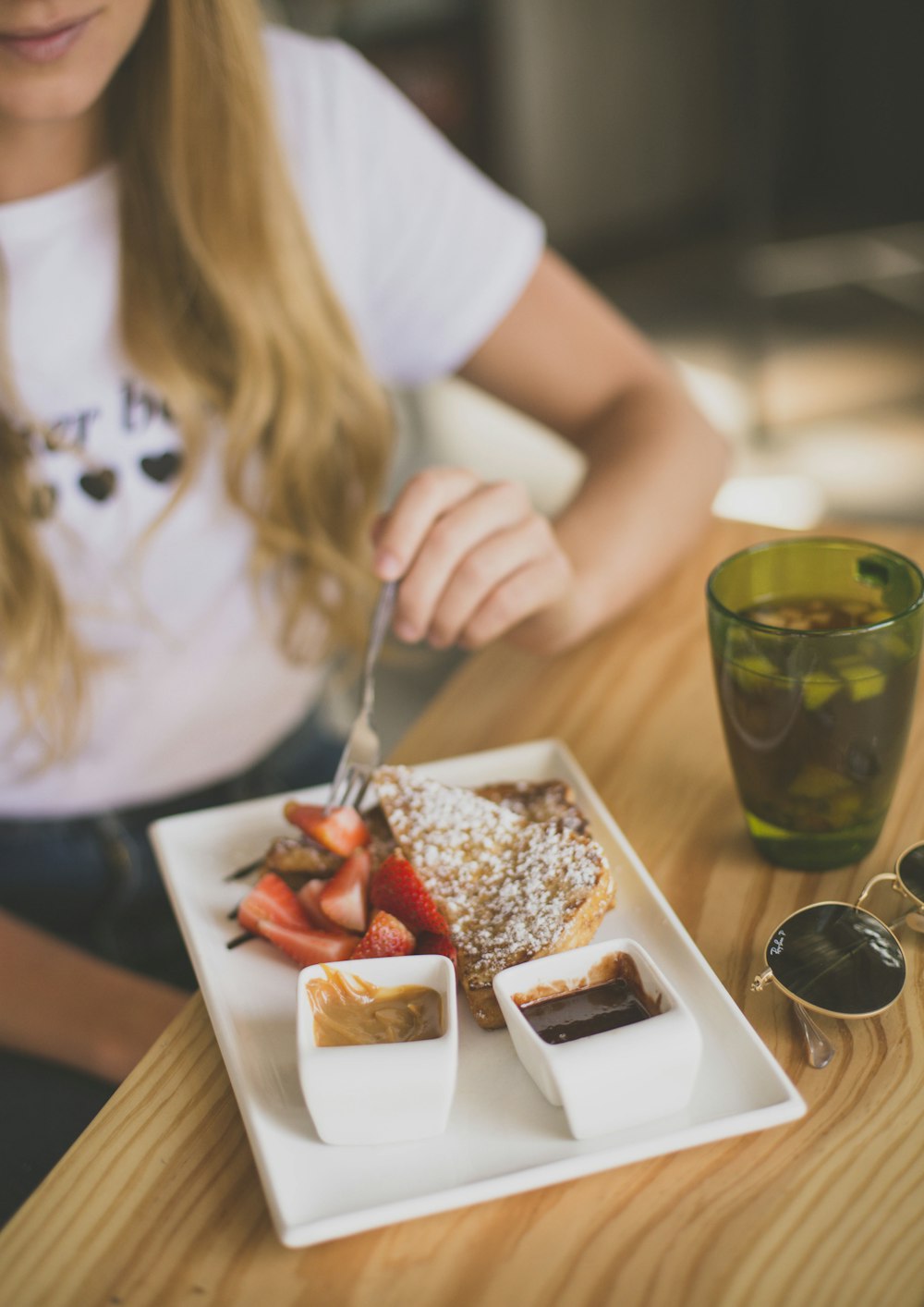 girl eating strawberry waffle