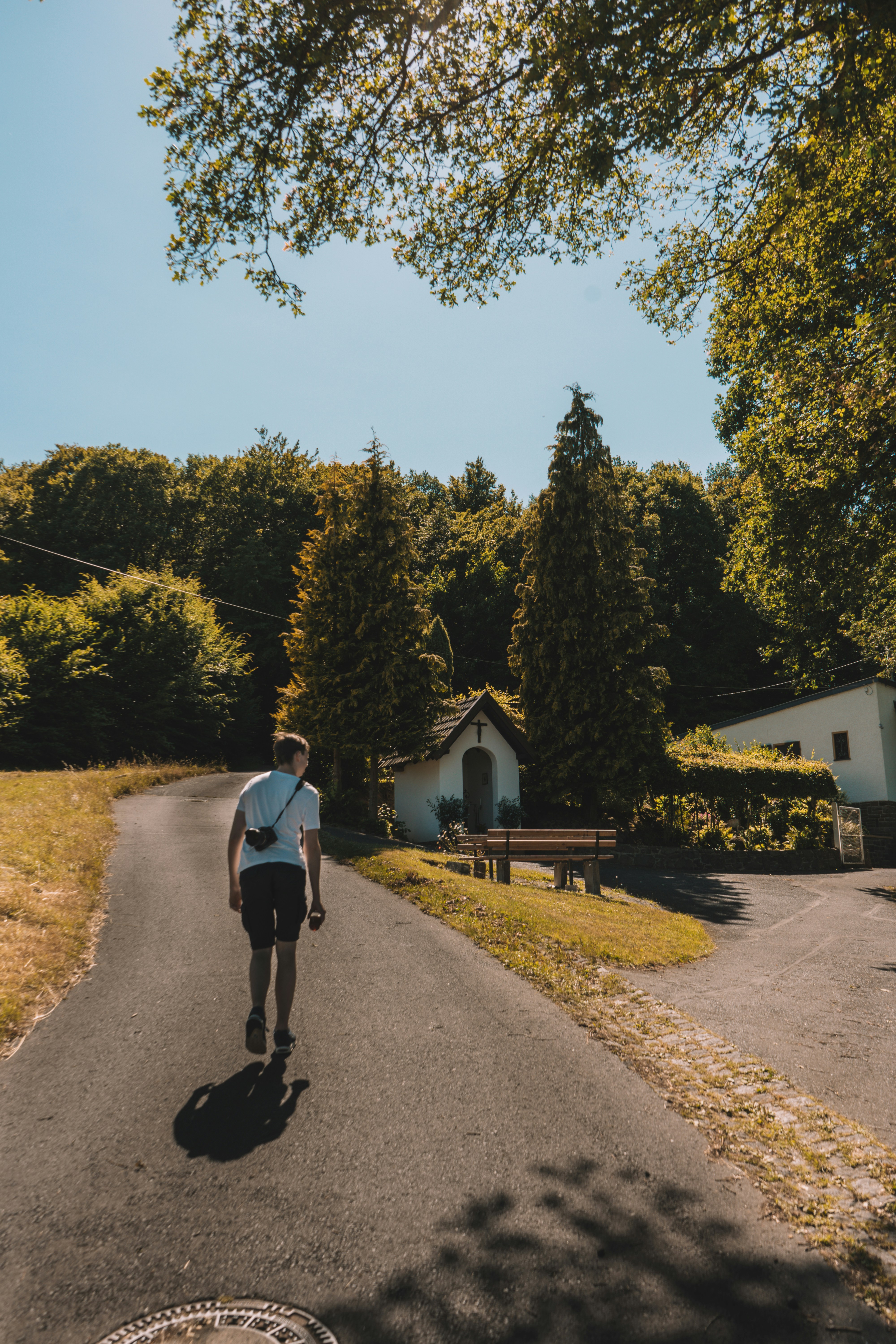 man walking along road beside cathedral