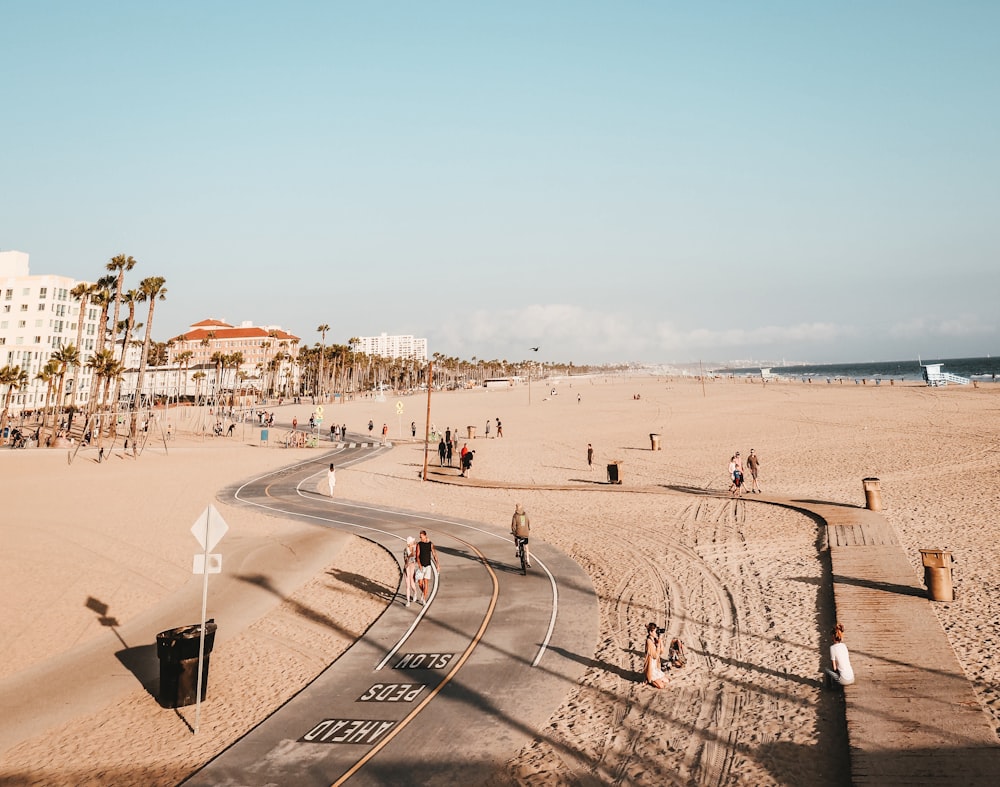 people on road and sand