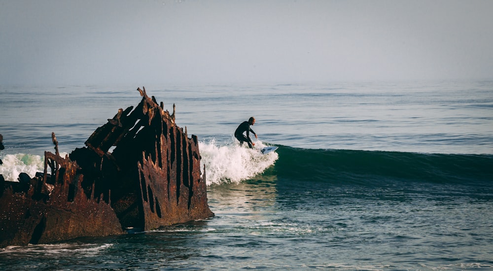 man surfing the waves during day