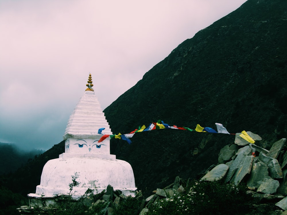 white concrete temple near mountain under white sky