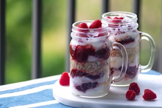 strawberry ice cream in clear glass jars