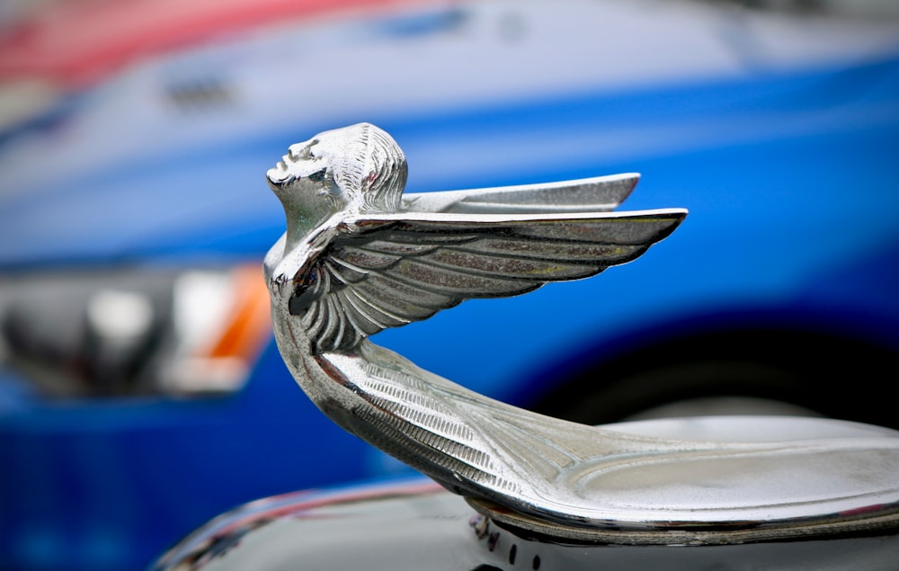 chrome angel car emblem shallow focus photography