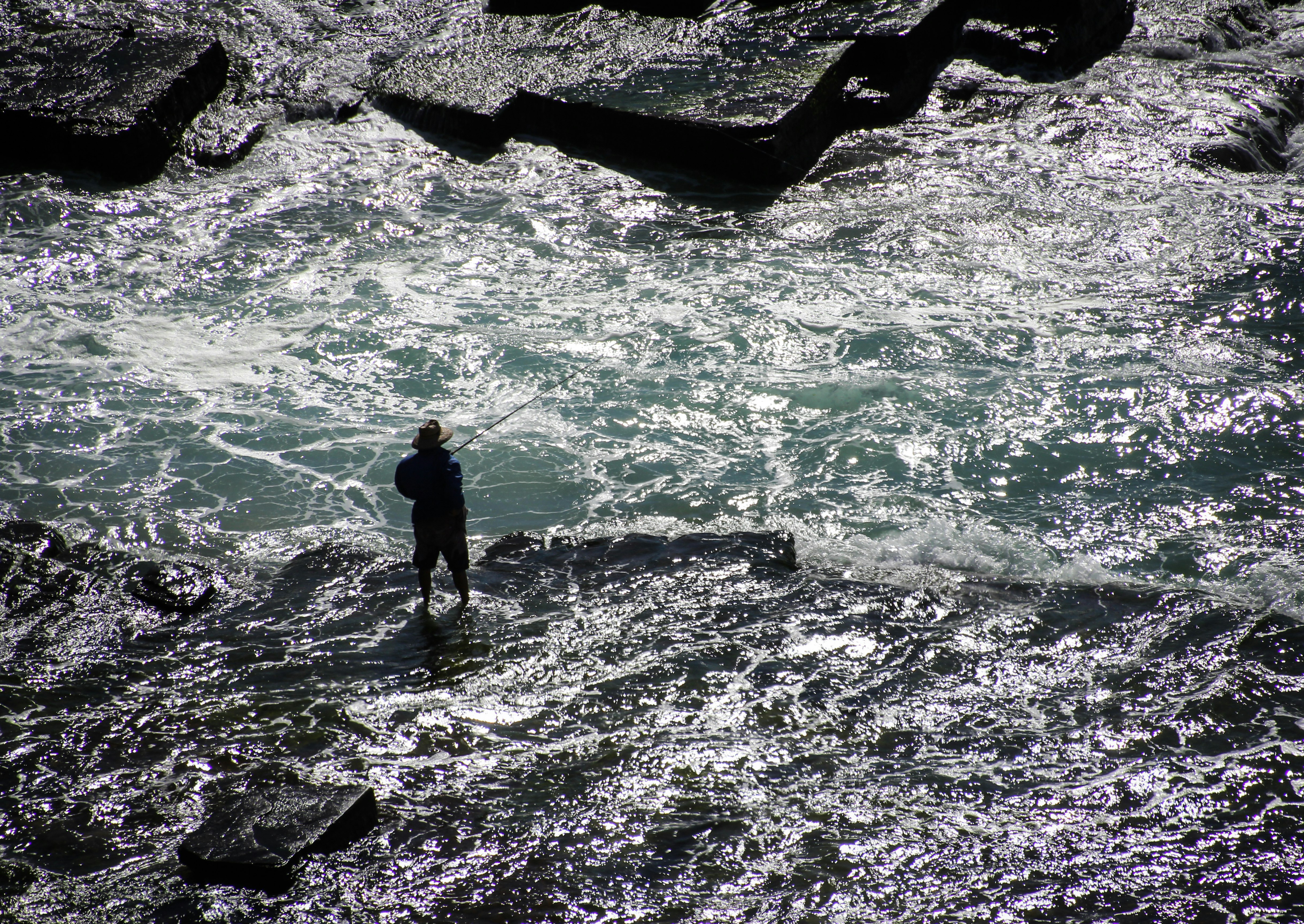 silhouette photography of person on body of water