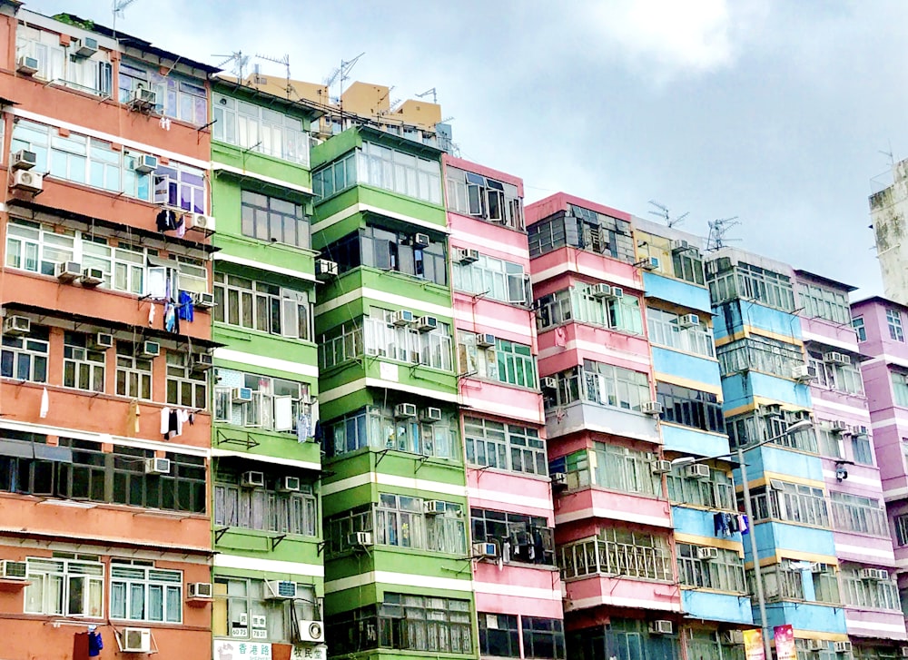 low angle photo of assorted-color buildings taken at daytime