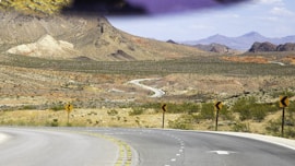 brown mountain near black concrete road