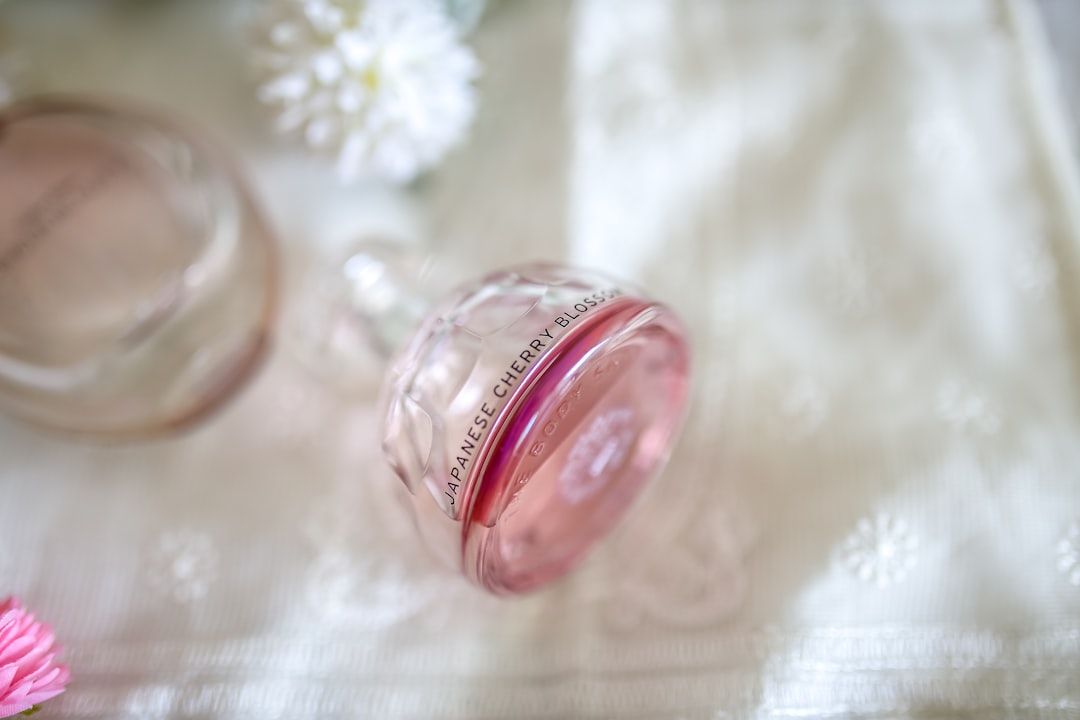 clear Japanese Cherry Blossom fragrance bottle on white textile
