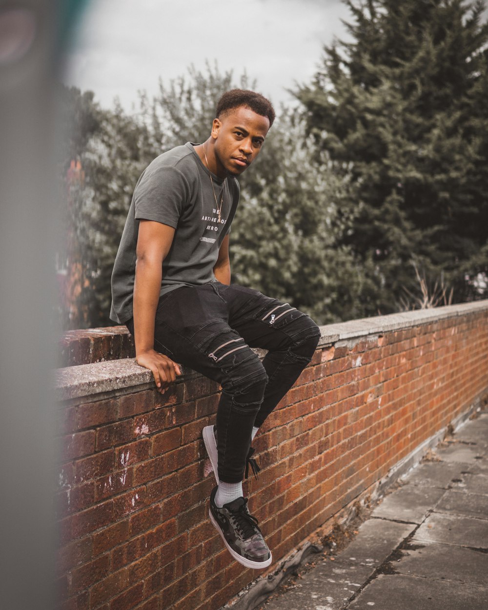 man sitting on brown wall