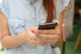 person holding using iPhone X