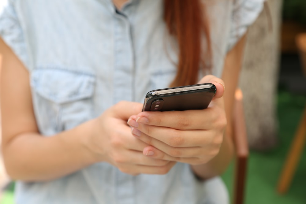 person holding using iPhone X