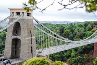 grey concrete bridge with people crossing