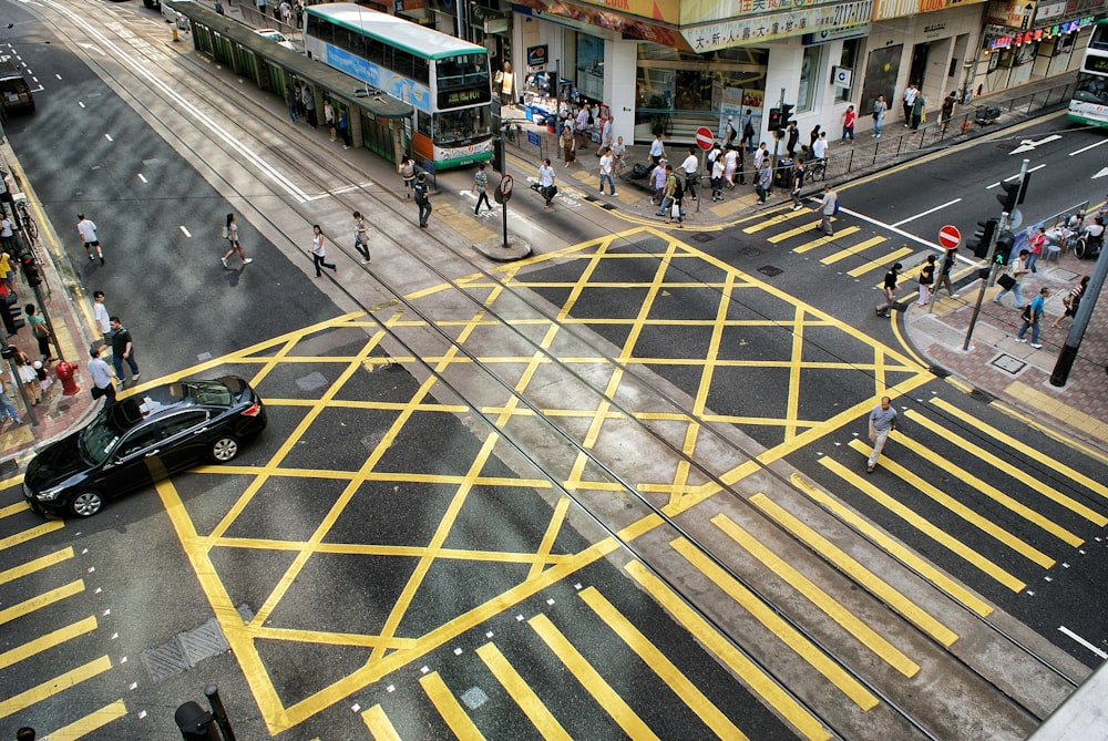 black vehicle near people during daytime