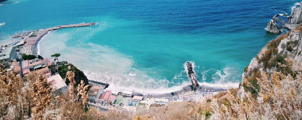 aerial photo of village beside large body of water