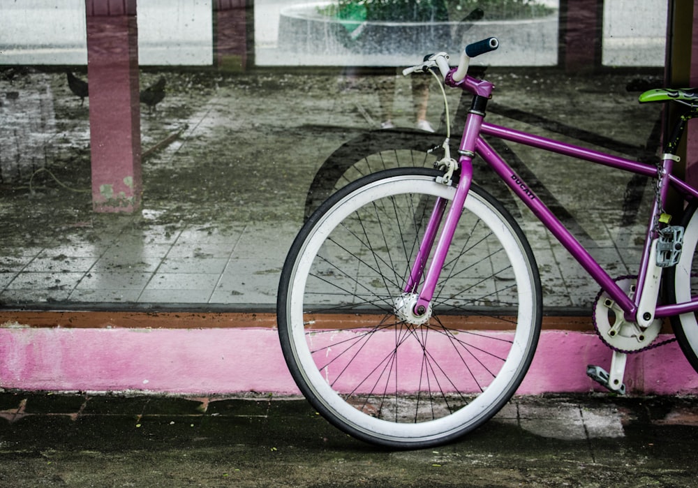 purple road bike on gray tile flooring