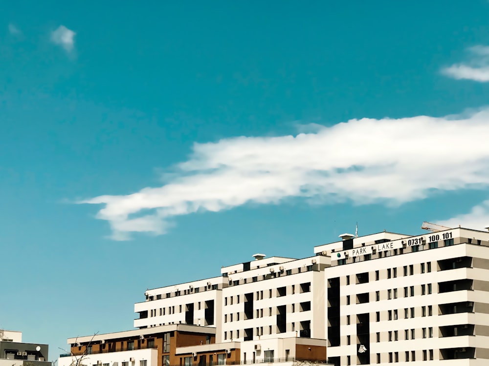 white concrete building under white clouds