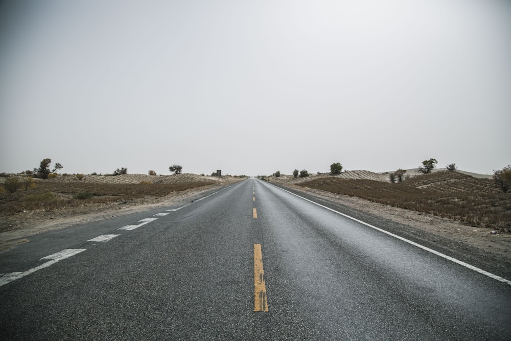 gray concrete road near gray soil