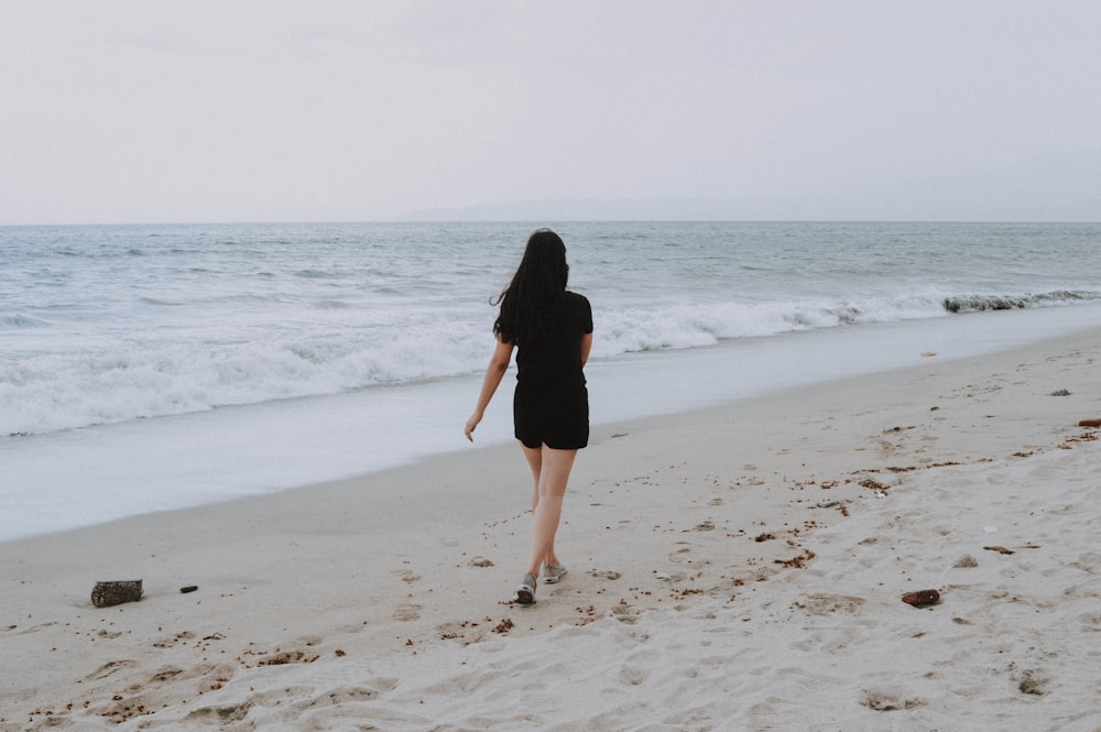 woman walking on beach shore