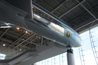 Visitors examining airframe parts with detailed traceability tags under bright exhibition lighting.