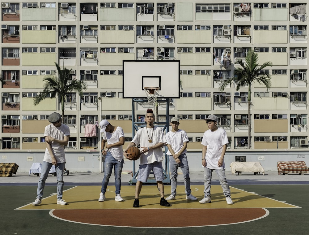 people standing on basketball court