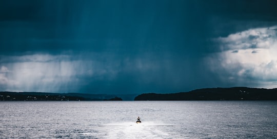 person riding watercraft at the middle of the sea in Filtvet Norway