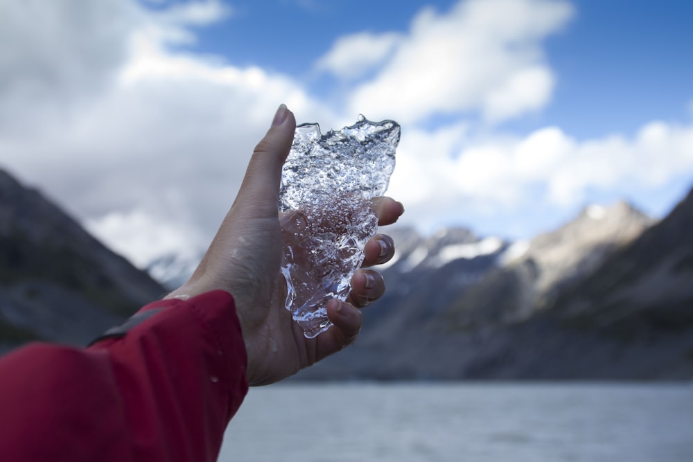 person holding clear ice