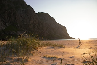 A scenic view of a coastal triathlon route with athletes running along the beach.